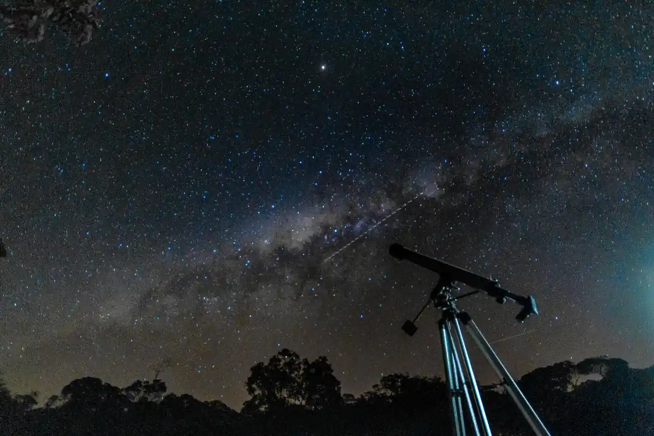 Milky Way core and starry sky above an observatory