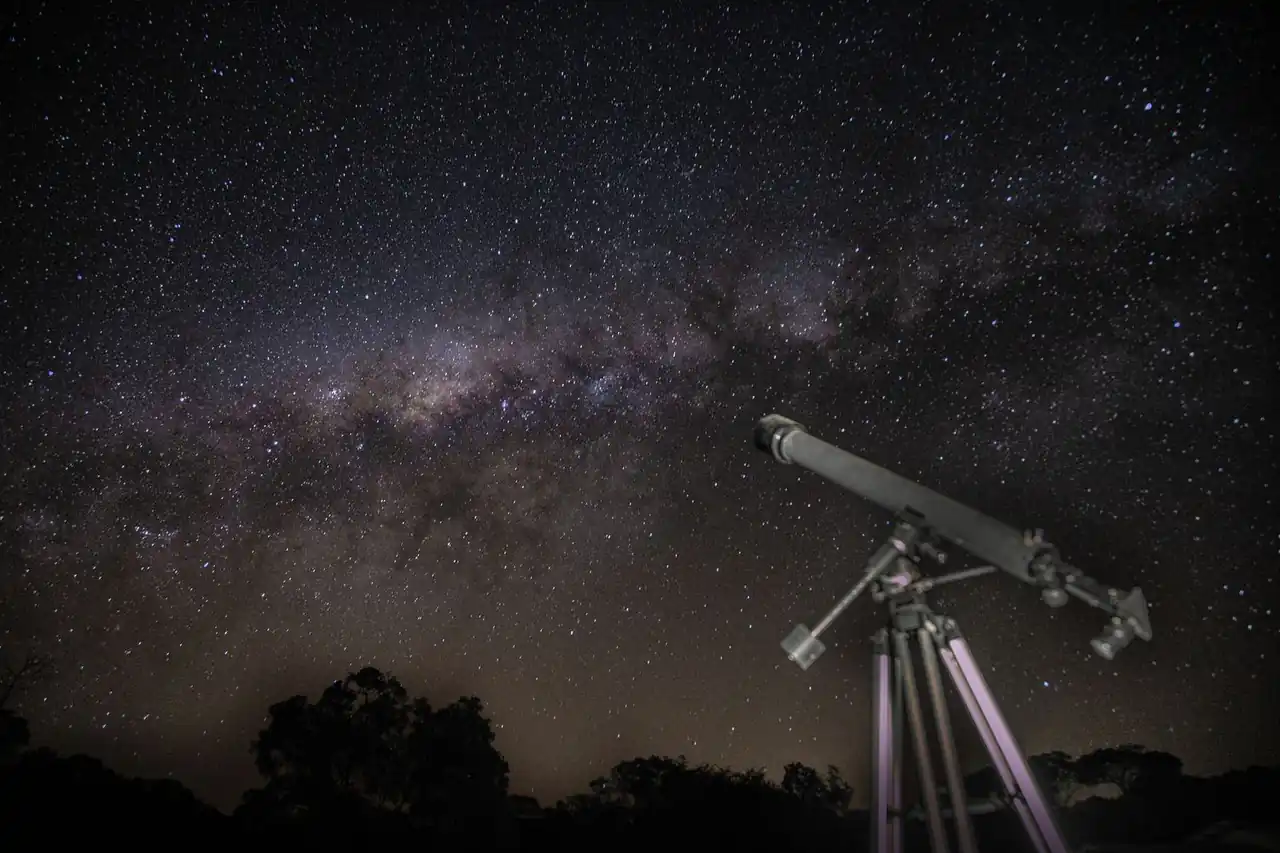 Astronomer using a large optical telescope